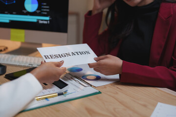 Businesswoman giving resignation letter to her manager in office meeting after she decided to resign from job, changing job, unemployment, resign concept