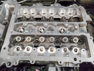 The petrol engine is being overhauled, the camshaft and spark plug assembly can be seen
