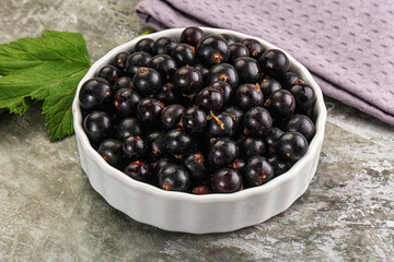 Ripe black currant in the bowl