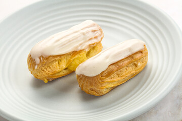 Delicous eclair with ising and cream