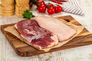 Raw duck breast over board
