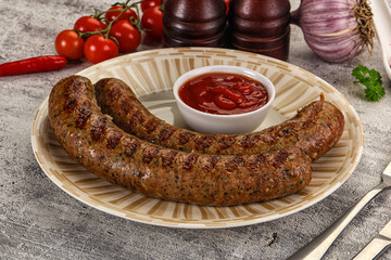 Grilled beef sausages with sauce