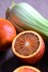 Close-up of a fresh blood orange cut in half, showcasing its vibrant red flesh and juicy texture.