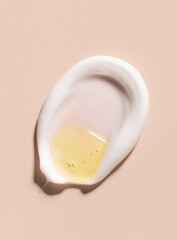 creamy texture of cosmetic samples on a pastel beige background