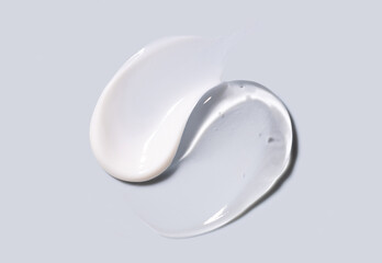 samples of cosmetic care products smear of cream and gel texture on gray background