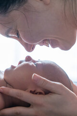 Naklejka premium Tender Moment Between Mother and Newborn