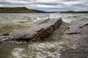 seascape with rocks against which waves crash