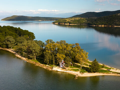 Aerial View of Scenic Peninsula with Chapel on Lake Ziros, Epirus, Greece


