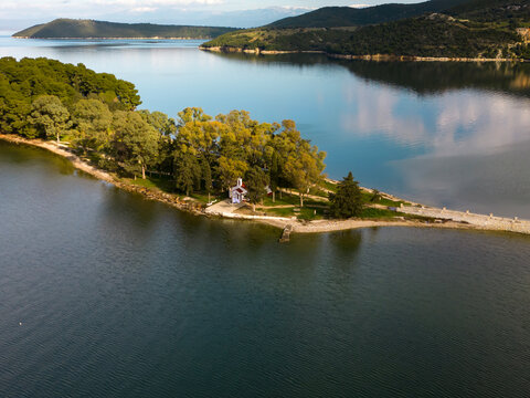 Aerial View of Scenic Peninsula with Chapel on Lake Ziros, Epirus, Greece

