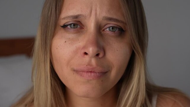 Close-up of a young blonde woman's face with tears of joy in her eyes. A heartfelt moment of deep emotional release, self-acceptance and unconditional love, expressed with tenderness, light and warmth