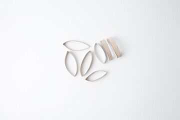 Cardboard pieces arranged for eco-friendly DIY projects, suitable for art teachers, educational kits, sustainable packaging brands, and craft content creators. Recycled material concept.