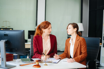 Fototapeta premium Professional female lawyers consulting on legal cases in a modern office. Perfect for law, business, justice