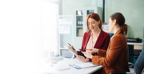 Professional female lawyers consulting on legal cases in a modern office. Perfect for law, business, justice