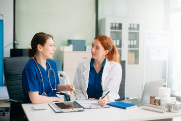 Medical team in hospital using digital tablet for diagnosis, teamwork, and patient care doctor and nurse collaboration