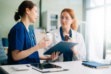 Medical team in hospital using digital tablet for diagnosis, teamwork, and patient care doctor and nurse collaboration