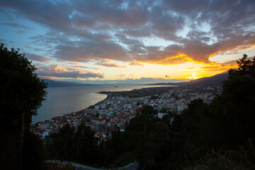 Sunset Over Coastal City and Sea in Greece
