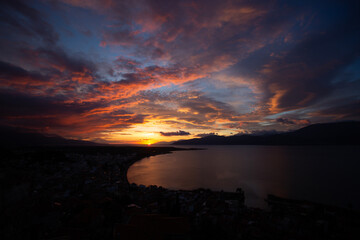 Sunset Over Coastal City and Sea in Greece