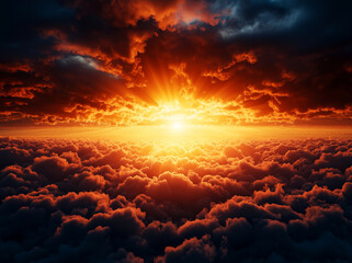 Fototapeta premium Breathtaking sunset over clouds with vibrant orange and red rays illuminating sky, creating dramatic and serene atmosphere