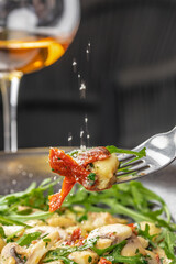 Italian Traditional potato gnocchi with smoked bacon, arugula, parmesan cheese. Top view. Copy space