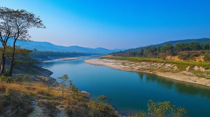 Obraz premium A calm landscape with a clear blue sky, a river flowing through a valley, to commemorate World Water Day, emphasizing water conservation pic