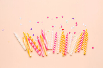 Birthday candles and glitter on pink background
