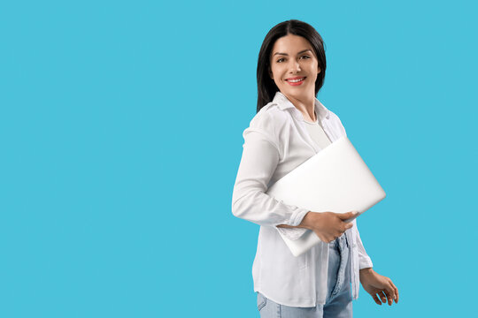 Female programmer with laptop on blue background