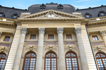 the Architecture Palace Facade Neoclassical, round windows, stone ornaments and a clock on the roof top