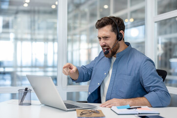 A furious customer service representative, wearing a headset, has an outburst in response to a...