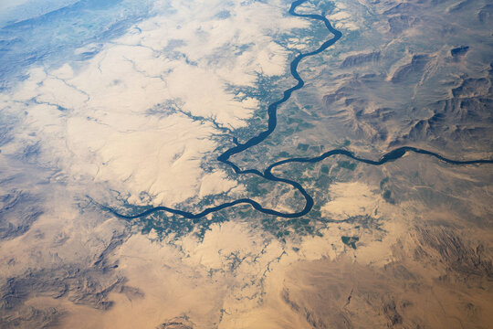 Euphrates river meandering through arid landscape, creating fertile oasis, aerial view