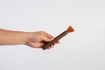 Hand using a little paintbrush isolated on a white background