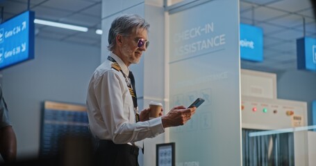 Professional Airline Pilot in Uniform Drinking Coffee, Using Smartphone. Flight Crew Member Waiting...