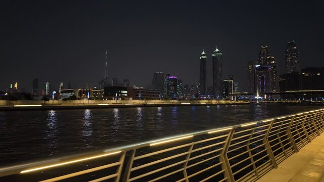 Modern Dubai night cityscape, view from the water canal