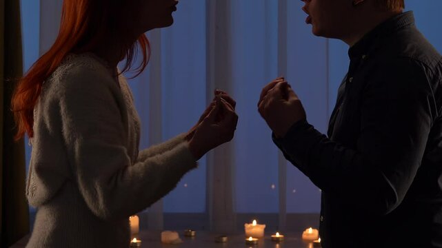 Couple Engaging In Intense Discussion By Candlelight