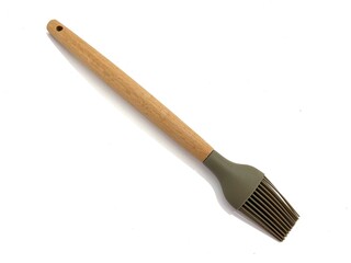 Silicone kitchen basting brush with wooden handle, ideal for baking and grilling. Durable and heat-resistant. Isolated on white background.