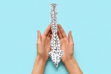 Woman with paper spine on blue background