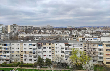 Depressing communist architecture overview in Eastern Europe , Romania , showing many rows of grey looking blocks , typical urban landscape 