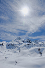 Sunshine on the  now covered Monte Madonnino (Alpine peak), in the Alpine basin of the Calvi refuge, where the 'Trofeo Parravicini', the famous ski mountaineering race, takes place every year.