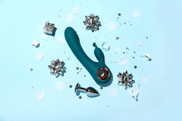 Composition with vibrator, anal plug and decorations on color background