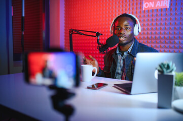 African american video blogger records content in his studio.