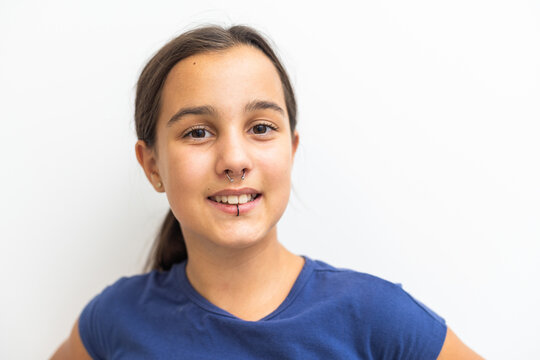 Closeup of a young teen girl's visage with piercing hanging from her lip