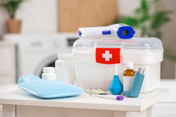 Home first aid kit with medical supplies on table in bathroom, closeup