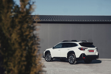 A modern subcompact crossover SUV in white with beautiful wheels and a large chrome grille.