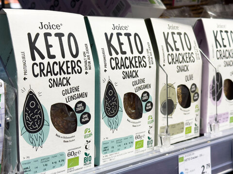 Assorted keto crackers display on store shelf with nutritional labels