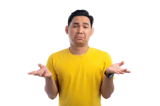 I don't know. Handsome Asian man shrugging shoulders with confused facial expression isolated on transparent background