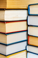 stack a large pile of printed books lies on the table, book covers and pages for study