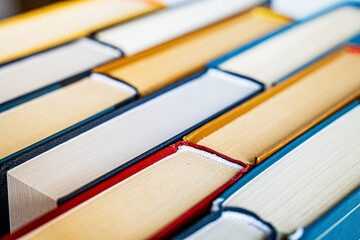 stack a large pile of printed books lies on the table, book covers and pages for study
