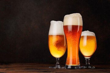 A selection of various beer glasses filled with different types of beer