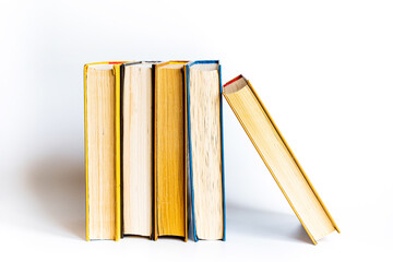 stack a large pile of printed books lies on the table, book covers and pages for study