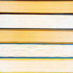 stack a large pile of printed books lies on the table, book covers and pages for study