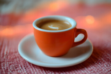 Fototapeta premium Close-Up Shot Of An Espresso Cup With A Saucer, Set Against A Soft Bokeh Background, Creating A Cozy Cafe Vibe With Warm Lights And A Relaxing Atmosphere Perfect For Coffee Lovers.